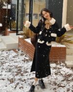 Retro Style Winter Set - French Aesthetic outfit, a black knit skirt and jacket with faux fur trim, worn outdoors in snowy weather.
