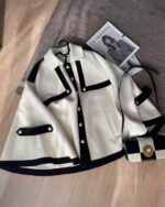 Close-up of a french style cape coat, aesthetic vintage design with buttons.