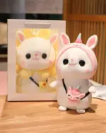 Cotton the Adventurous Kawaii Hatted Bunny Plushie with a unicorn companion, displayed in a box.