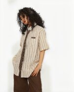 Vintage striped short sleeve shirt in a preppy aesthetic, featuring a relaxed fit and subtle branding.