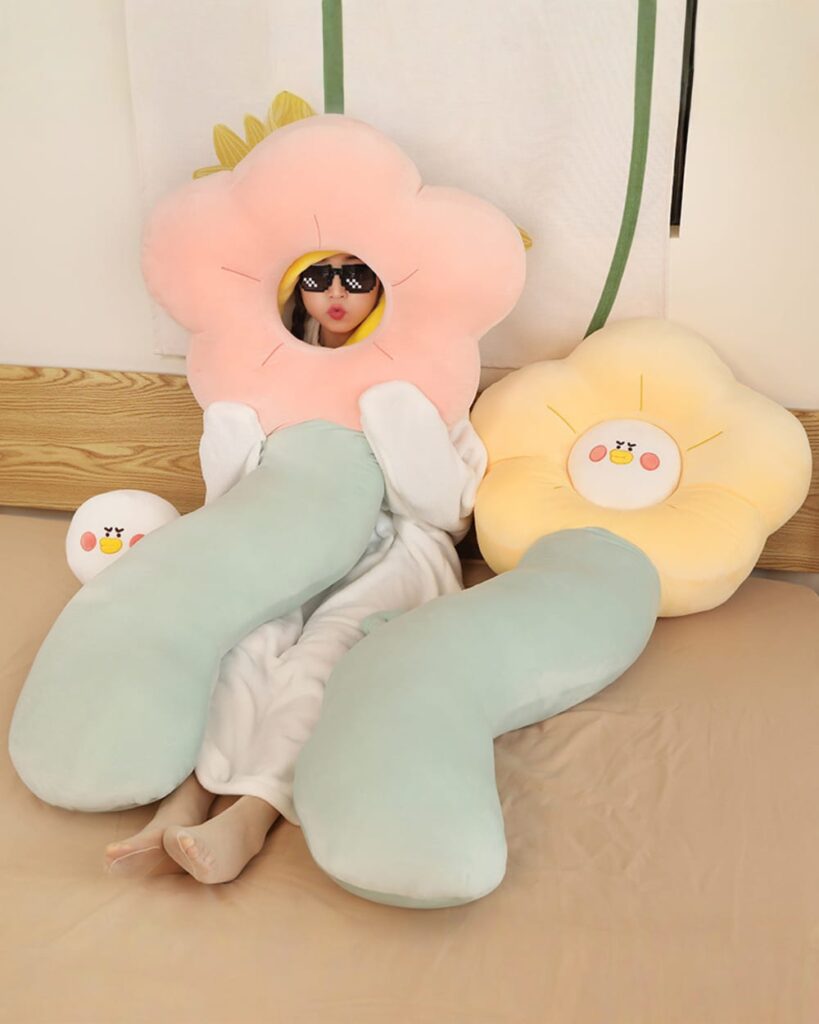 Kawaii angry flower plushie pillows with removable head, one pink and one blue.