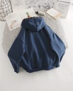 Blue ethno-chic hoodie, featuring a patterned trim and relaxed fit.