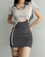 Gray tied coquette aesthetic dress with sheer top and thigh-high stockings.
