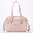 Light pink japanese schoolbag featuring a heart-shaped pocket and shoulder straps.