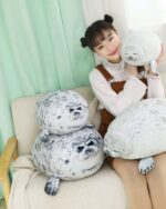 Yuki the Seal Plush and Arale plush toys, displayed with a girl.