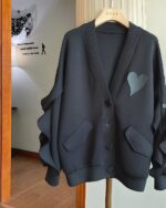 Black lace cardigan kawaii, long sleeve, hanging on a hanger.