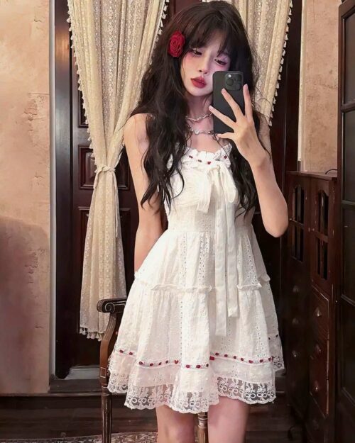 Lolita white laced dress, a tiered, ruffled dress with lace details and a cottagecore aesthetic.