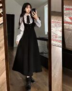 Elegant Uniform Set - Preppy Aesthetic: A woman wearing a black dress with white shirt and tie, capturing a preppy aesthetic.