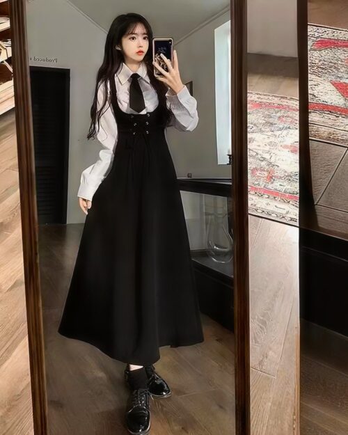 Elegant Uniform Set - Preppy Aesthetic: A woman wearing a black dress with white shirt and tie, capturing a preppy aesthetic.