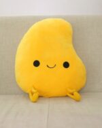 Yellow kawaii fruit plushie with black eyes, nose, and a smiling mouth.