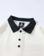 White cat graphic tee with a collar and buttons. Cat graphic tee.