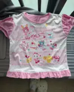 Kawaii pink princess t-shirt featuring cute character illustrations on a pink and white patterned fabric.