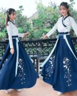 Two people wearing a blue hanfu summer dress with floral embroidery, standing outdoors.