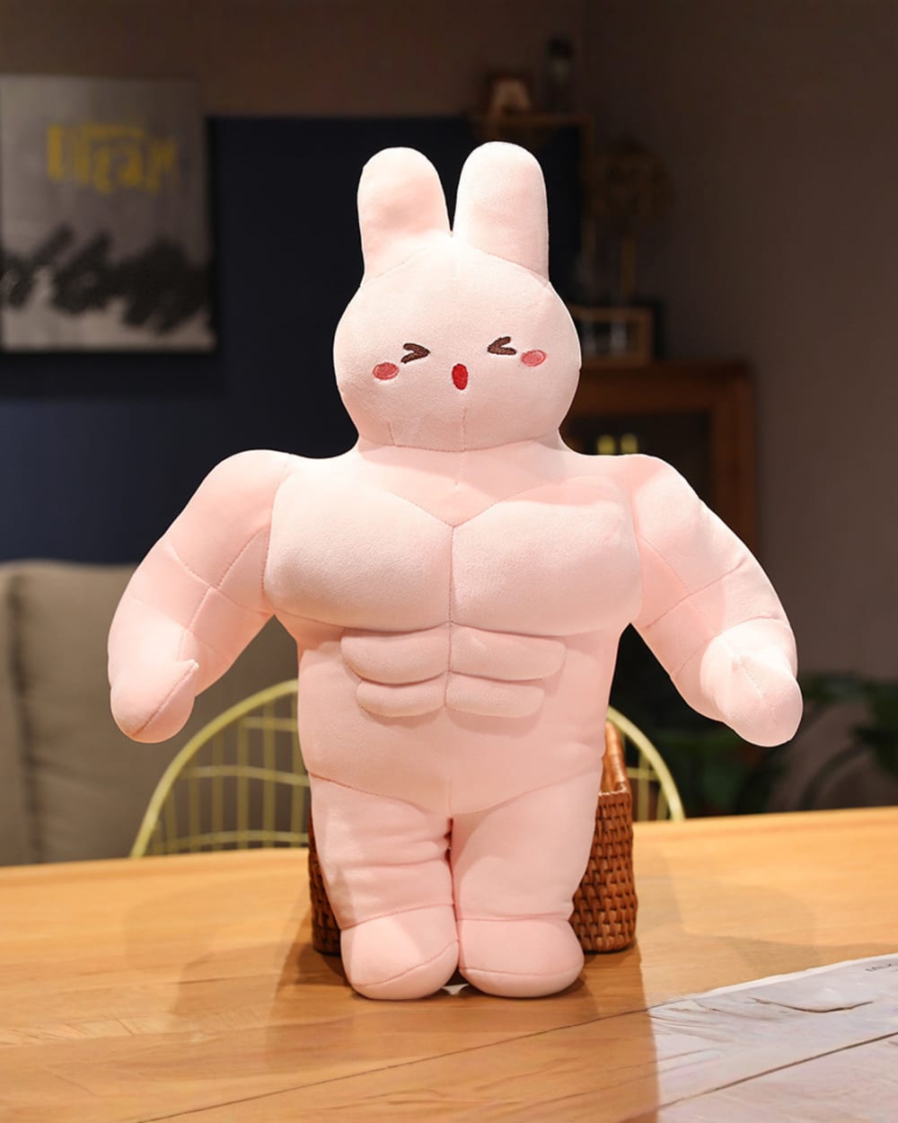 Pink buff bunny plushie with visible musculature, soft fabric material.