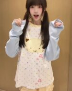 A light blue harajuku cat sweatshirt featuring a cute cat design and floral accents.