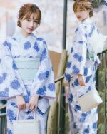 Two women wearing a blue japanese yukata with floral pattern, summer style.