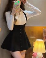 Black halter dress with a Korean aesthetic design, featuring a button-up front and gathered skirt.