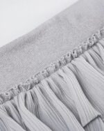 Close-up of a gray y2k aesthetic skirt with pleats and a high waist.