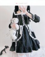 Black lace gothic lolita dress with ruffles, chain, and a plush toy.