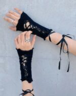 Black gothic fishnet gloves with lace-up detailing on wrists, showcasing a dramatic aesthetic.