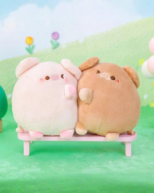 Two kawaii piggy keychain plushies, a pink and brown couple, sitting together.