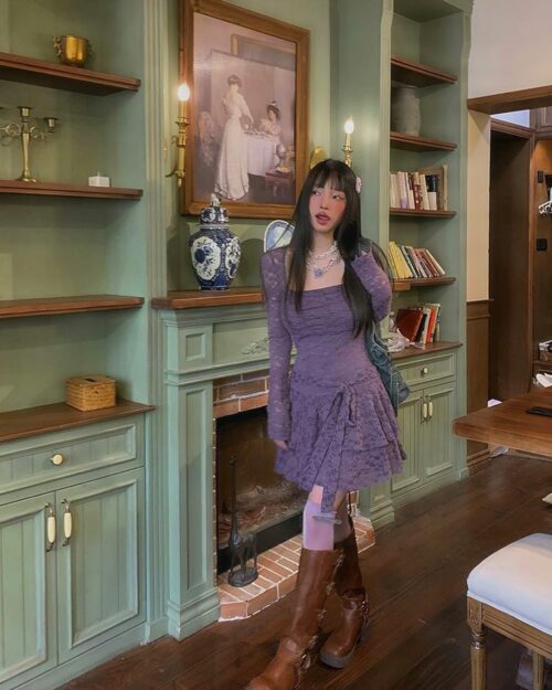 Purple lace spring dress featuring a gothic aesthetic, long-sleeved, and worn with boots.