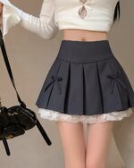 Pleated black Korean aesthetic skirt with bows and lace trim.
