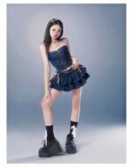 Model wearing a blue y2k aesthetic skirt with corset and platform boots.