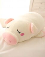 Close-up of a kawaii piggy plushie, soft and stuffed with pink accents.