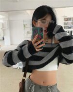 Black and gray retro aesthetic sweater with off-the-shoulder cut, layered style.