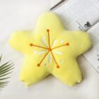 Close-up of a Sakura flower pillow, a star-shaped cushion with a white floral design.