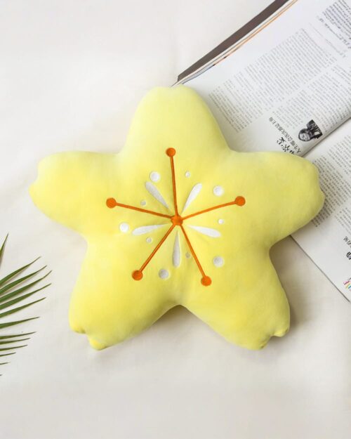 Close-up of a Sakura flower pillow, a star-shaped cushion with a white floral design.