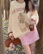 Cream-colored bunny aesthetic sweater with a vintage design, featuring a bunny illustration and lettering.