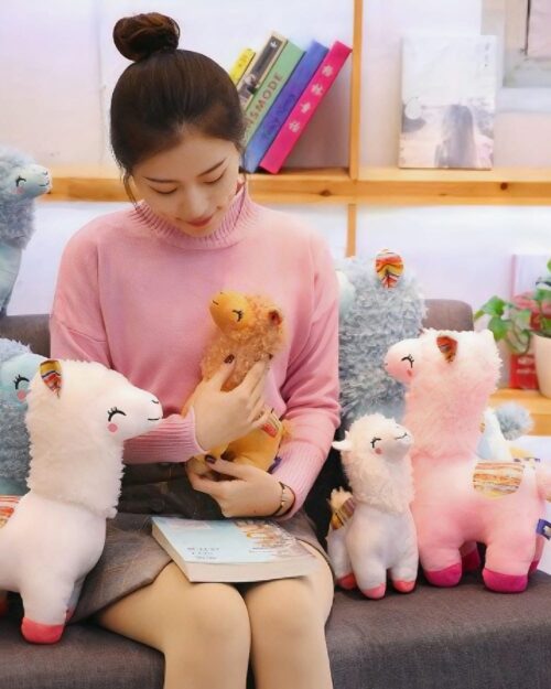 Close-up of several Happy Llama Plushies, soft stuffed animals.