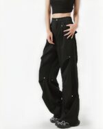Black Korean aesthetic pants with multiple pockets and a loose fit.