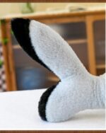 Close-up of the giant shark plushie's fin, showing soft gray and black texture.