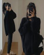 Black korean style sweater worn by a person in a mirror reflection.