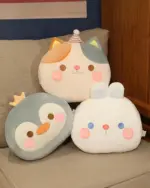 Round animal hand warmer plushies – cat, penguin, and panda designs displayed together.