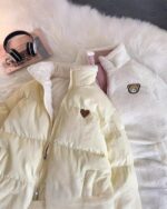 Cream-colored bear heart jacket with fluffy sherpa lining and a bear applique.