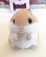 Close-up of a kawaii chibi hamster plushie, soft and fluffy toy.