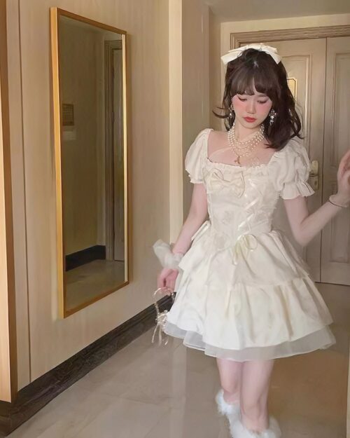 A cream-colored vintage aesthetic dress with a square collar and puff sleeves.