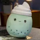 Cute green bubble tea plushie with a smiling face and a fluffy topping. These bubble tea plushies are adorable!