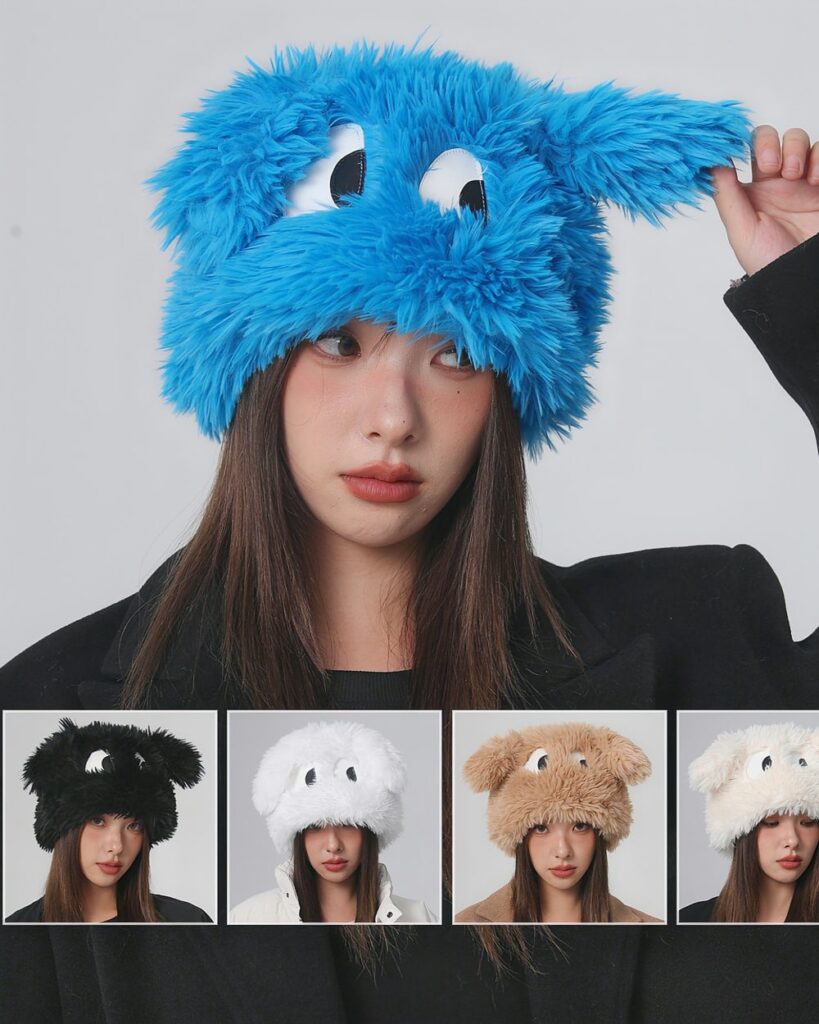 A fluffy eyed hat in blue, alongside other colored fluffy eyed hats.