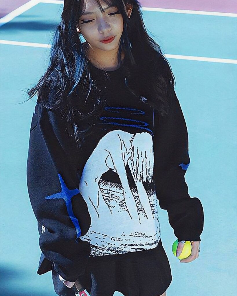 Black anime aesthetic sweater featuring a skull design, worn by a person outdoors.