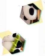 Close-up of a Pocket Panda Plush - Bamboo Edition, featuring black and white fur and a bamboo toy.