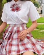 JK plaid skirt with a red and white plaid design, paired with a white blouse.