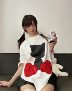 Model wearing an astro silhouette t-shirt with a black cat and red heart graphic.