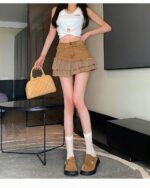 Ruffled y2k aesthetic skirt worn by a woman, featuring a denim design and tiered detailing.