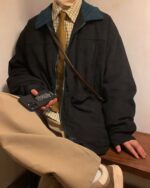 Black corduroy korean college jacket worn by a person.