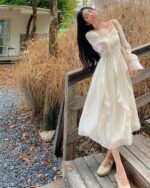 White French Style Long Sleeve Dress, a coquette aesthetic dress, worn by a woman outdoors.